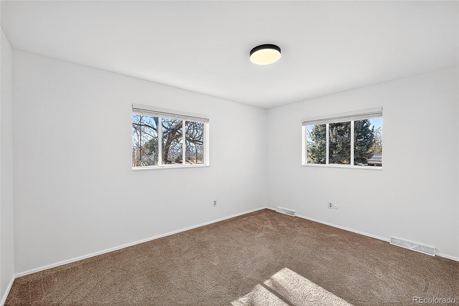2768 South Mabry Way Denver, CO 80236 - Photo 18 of 39 an empty room with windows