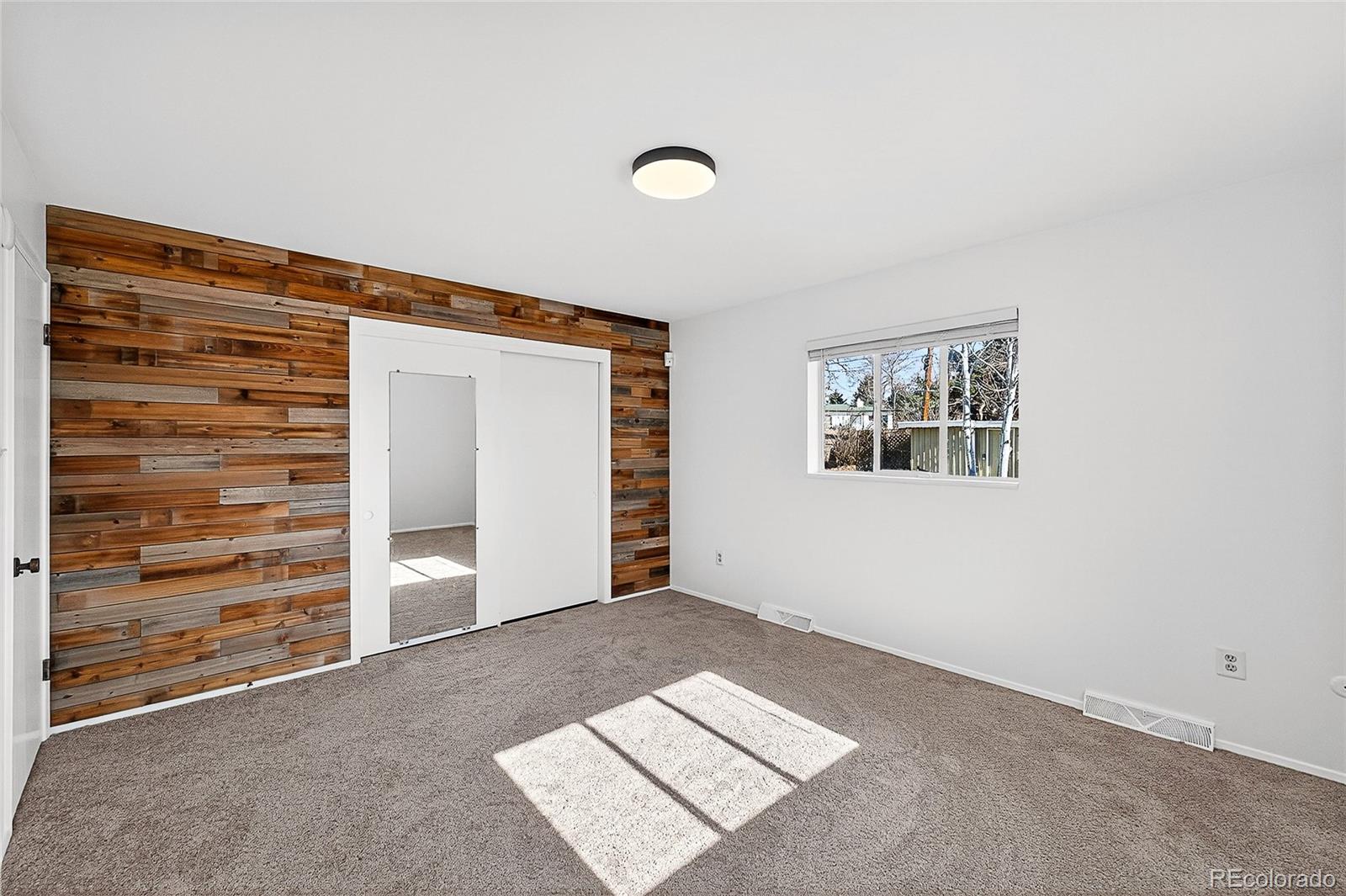 2768 South Mabry Way Denver, CO 80236 - Photo 21 of 39 an empty room with chair and closet