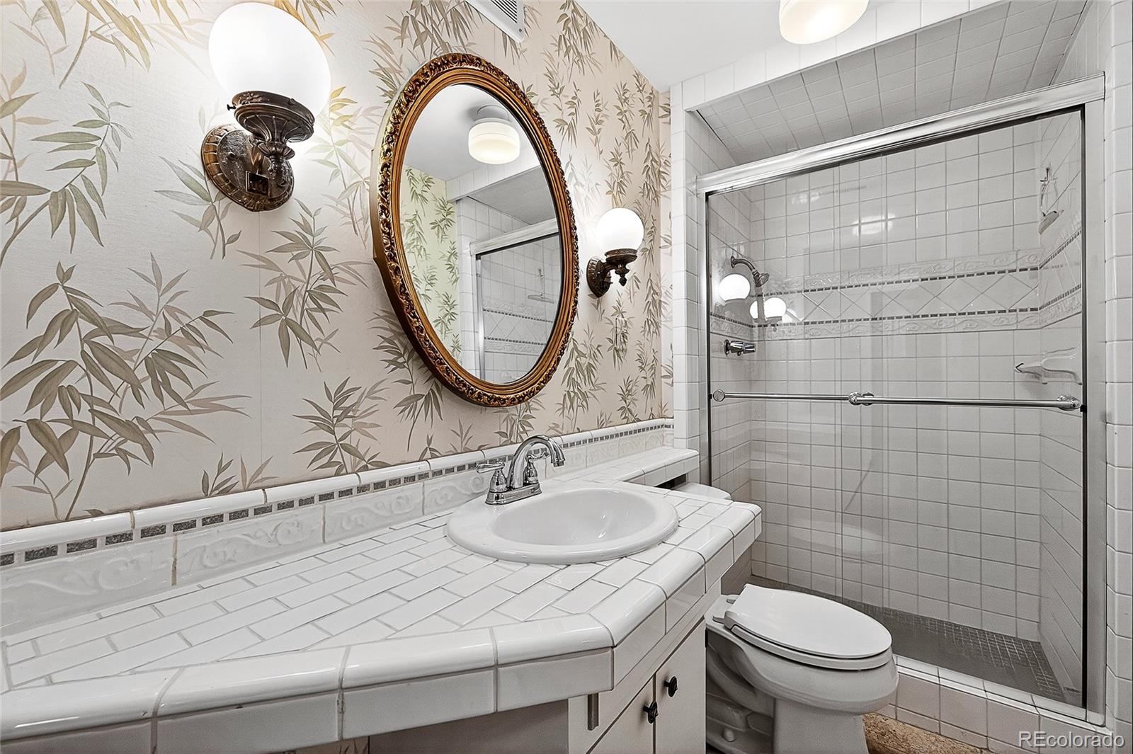 2768 South Mabry Way Denver, CO 80236 - Photo 23 of 39 a bathroom with a sink and a mirror