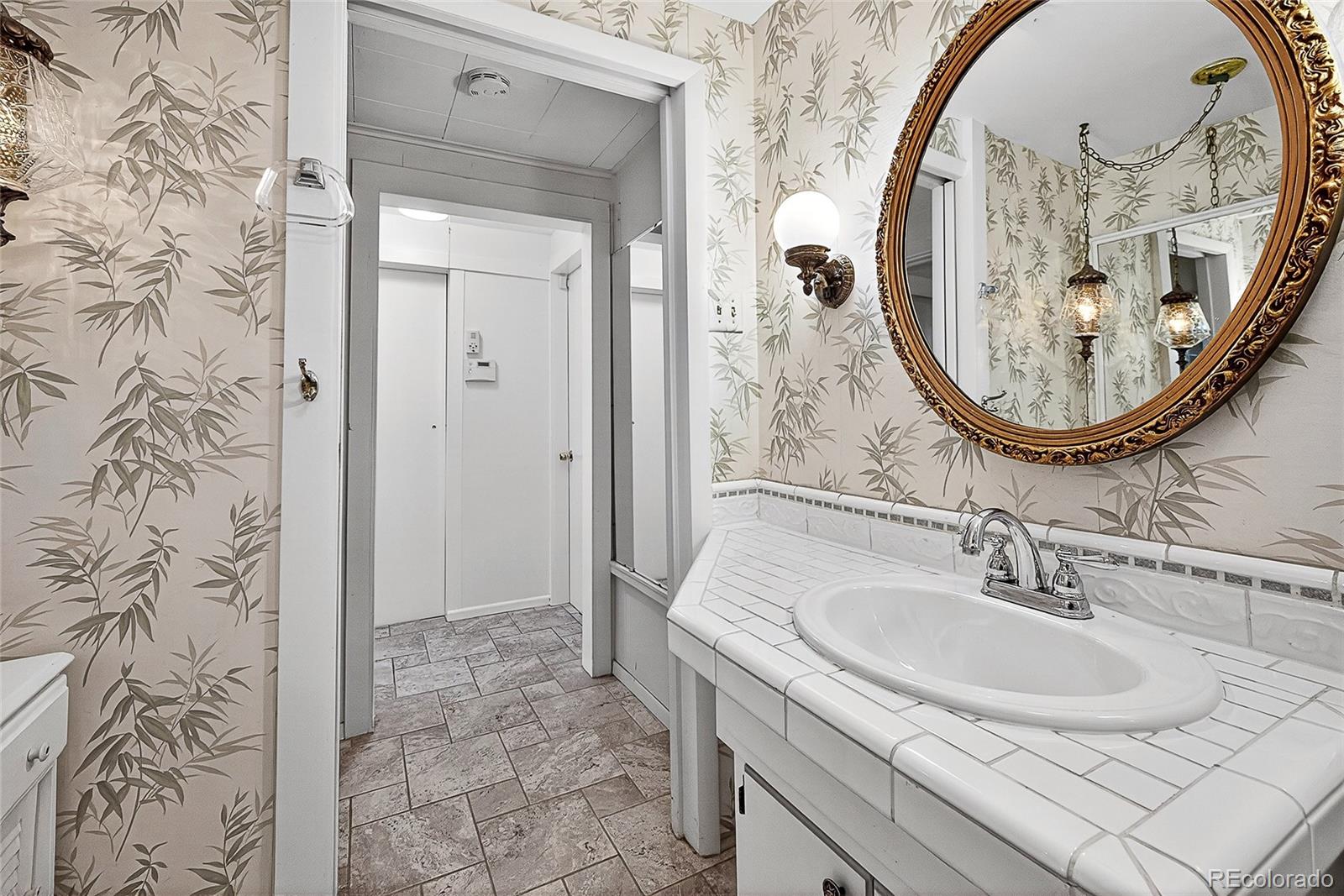 2768 South Mabry Way Denver, CO 80236 - Photo 24 of 39 a bathroom with a sink and a mirror