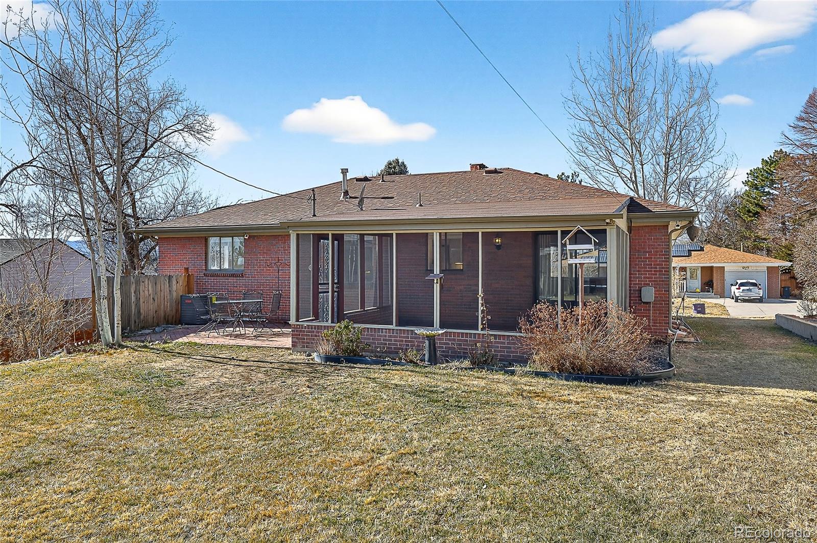 2768 South Mabry Way Denver, CO 80236 - Photo 35 of 39 a front view of a house with a garden