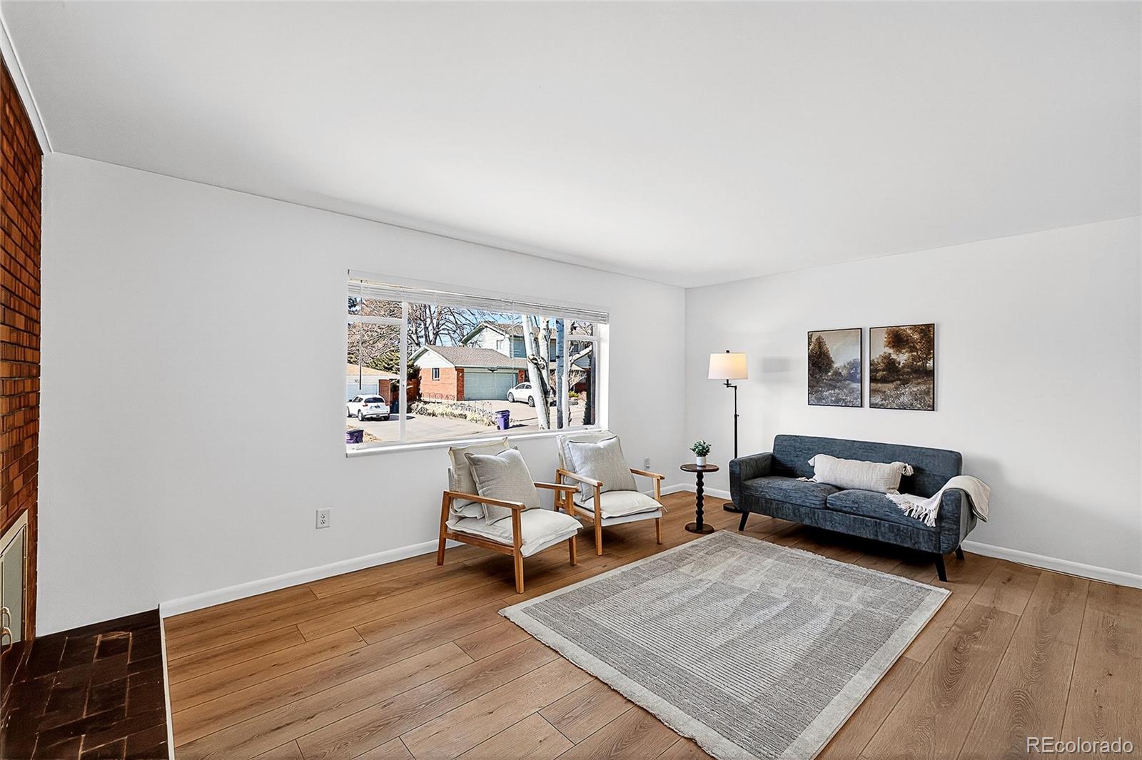 2768 South Mabry Way Denver, CO 80236 - Photo 4 of 39 a living room with furniture and a wooden floor