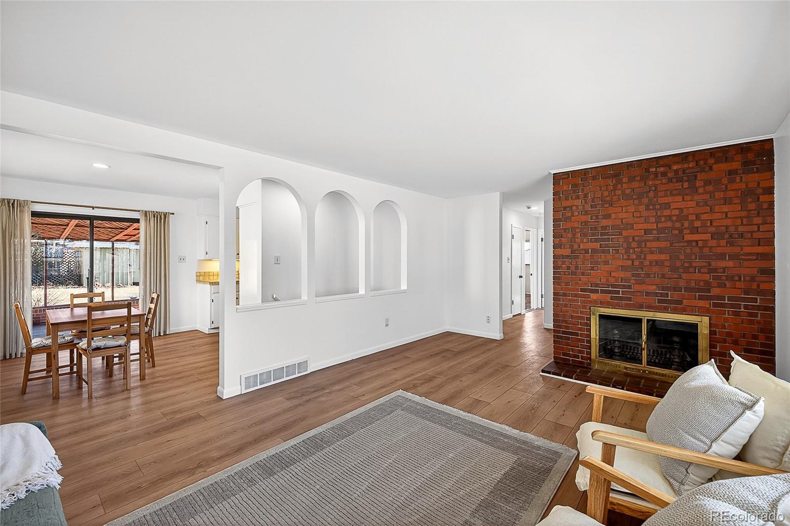 2768 South Mabry Way Denver, CO 80236 - Photo 5 of 39 a living room with furniture wooden floor and a fireplace