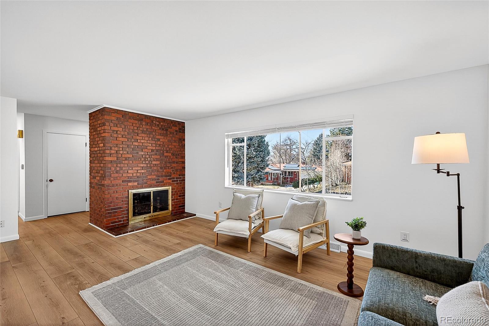 2768 South Mabry Way Denver, CO 80236 - Photo 6 of 39 a living room with furniture and a fireplace