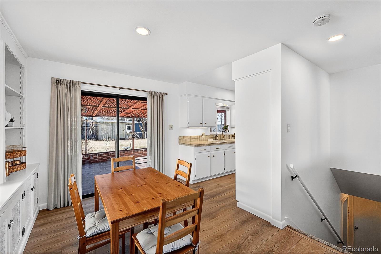 2768 South Mabry Way Denver, CO 80236 - Photo 7 of 39 a kitchen with a table chairs refrigerator and cabinets