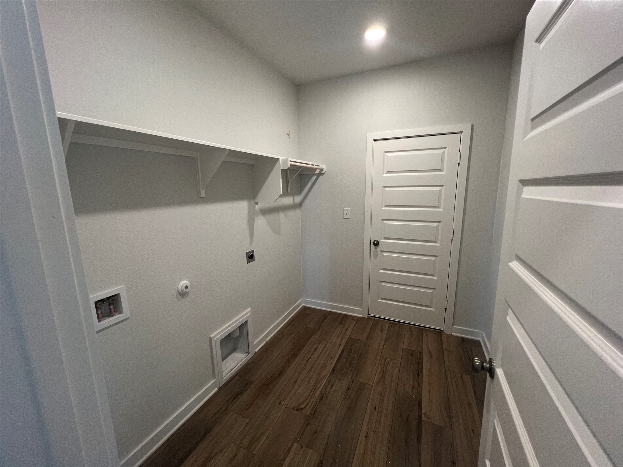 255 Gus Loop Georgetown, TX 78626 - Photo 16 of 24 A dedicated laundry room with ample shelving for storage and a durable wood floor.