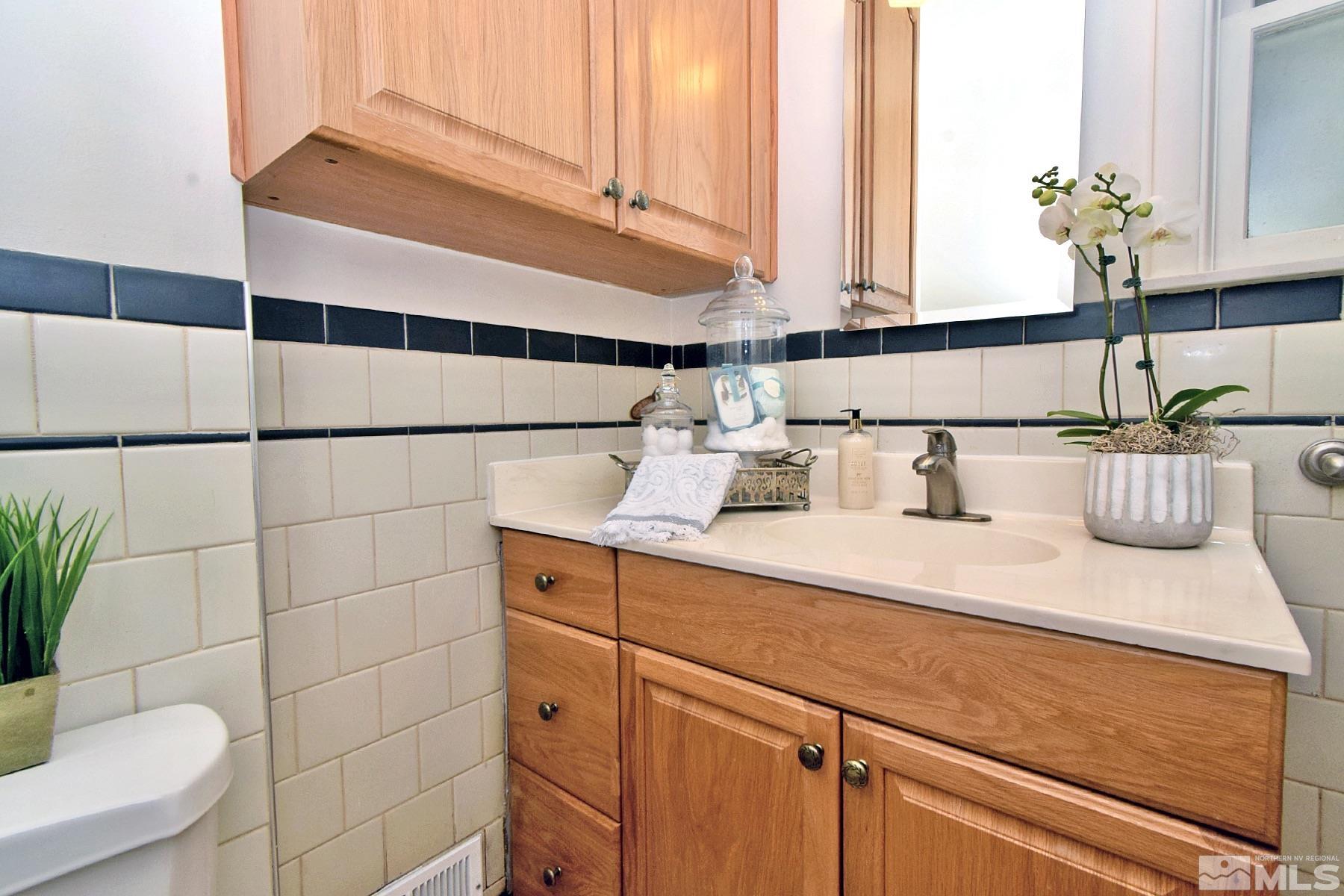 60 Suda Way Reno, NV 89509 - Photo 32 of 40 a bathroom with a sink and a mirror