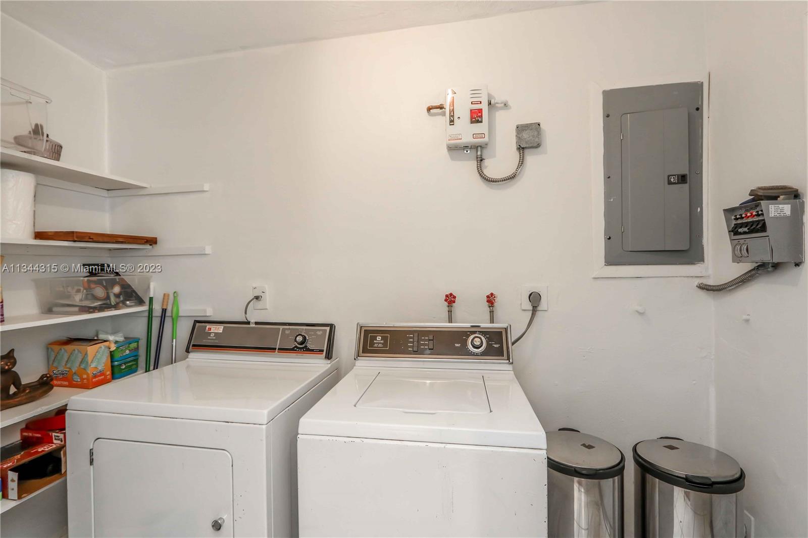 19310 Christmas Road Cutler Bay, FL 33157 - Photo 24 of 42 Laundry/ utility room with washer, dryer, storage, and instant on hot water heater (for high efficiency)