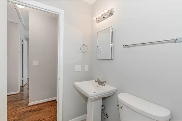 a bathroom with a toilet a sink and a mirror
