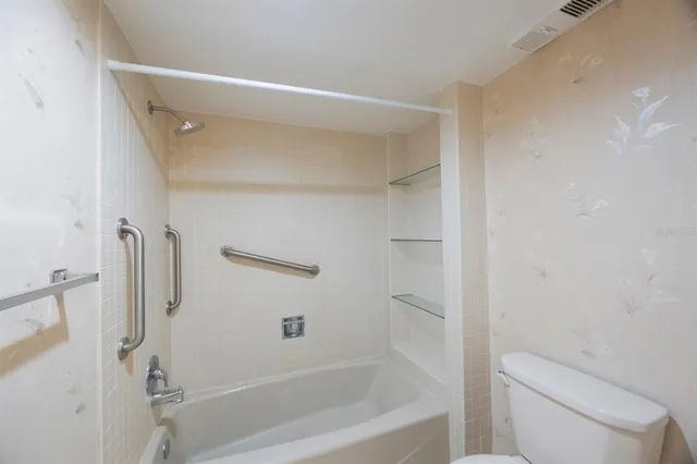 a bathroom with a shower and a toilet