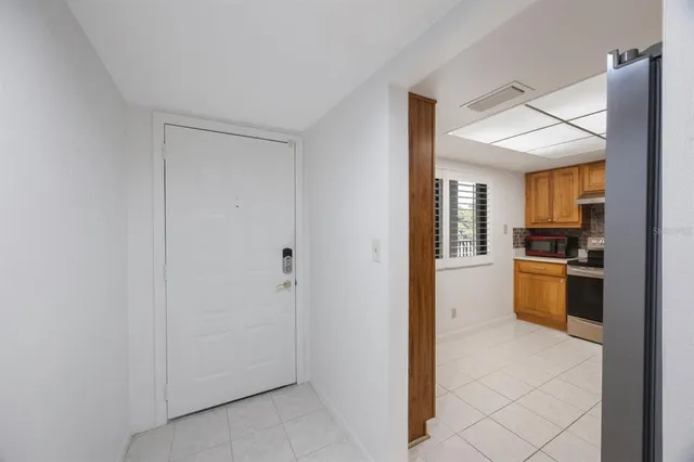 a view of kitchen with refrigerator and stove