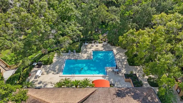 an aerial view of a house with a yard basket ball court