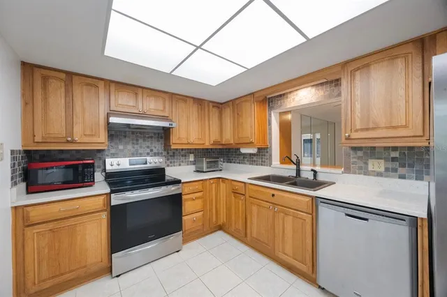 a kitchen with a sink stove and cabinets
