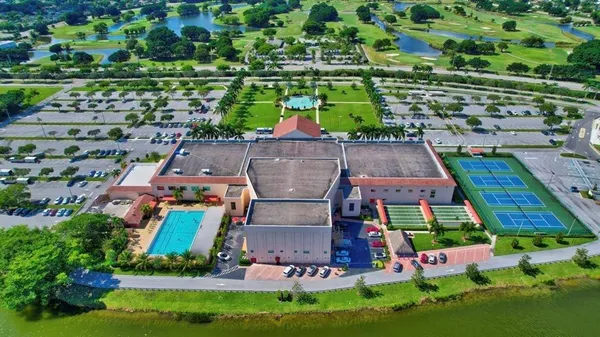 an aerial view of house with yard swimming pool and outdoor seating
