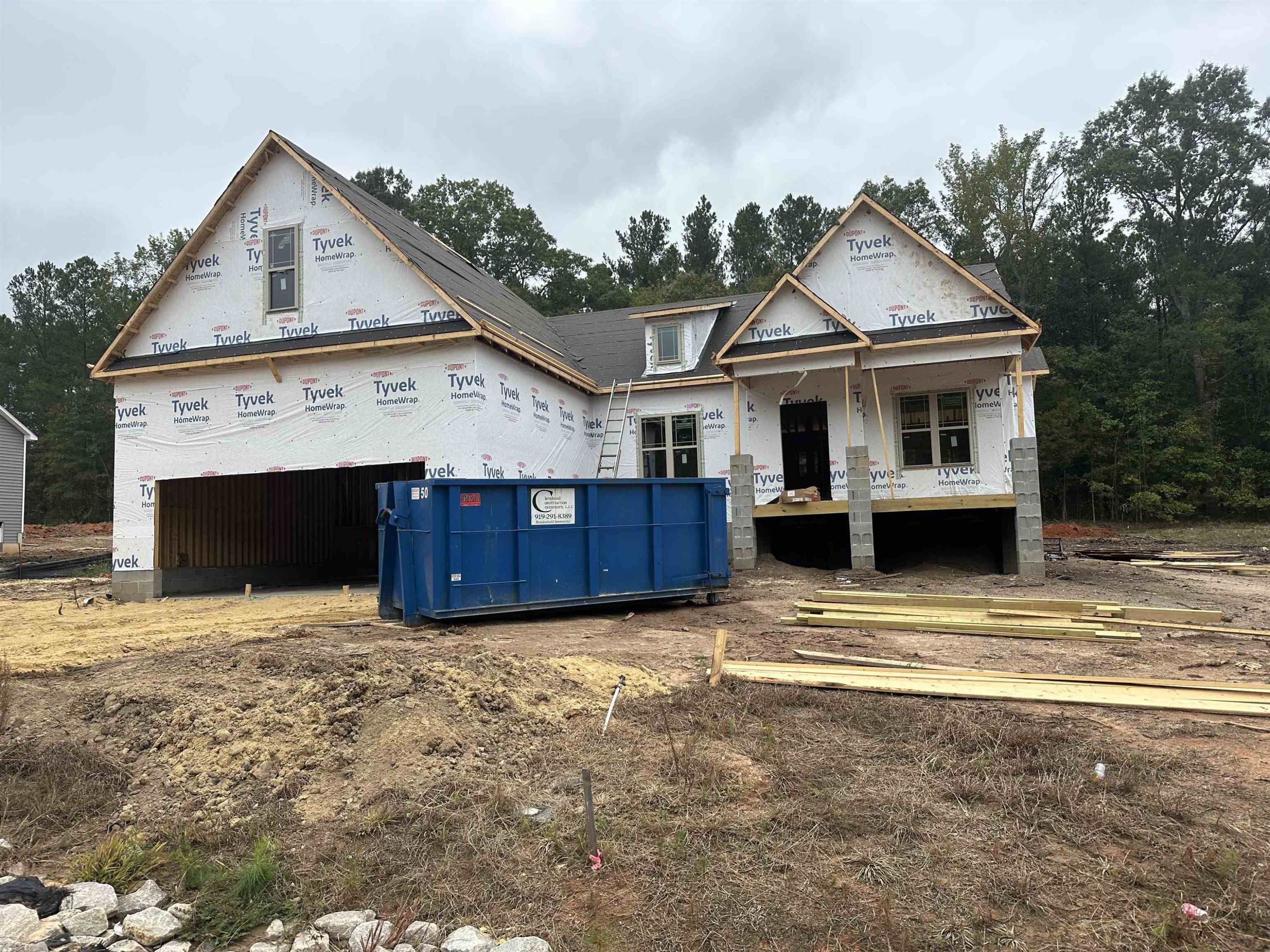 a view of a house with a small yard and wooden fence