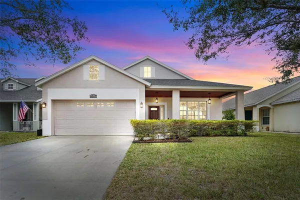 a front view of a house with a yard and garage
