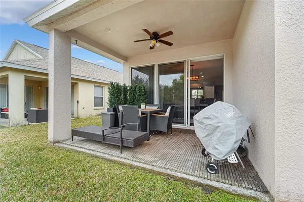 a view of an outdoor dining space with a table and chairs