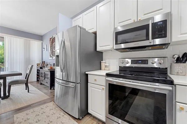 a kitchen with stainless steel appliances a stove a microwave and a refrigerator