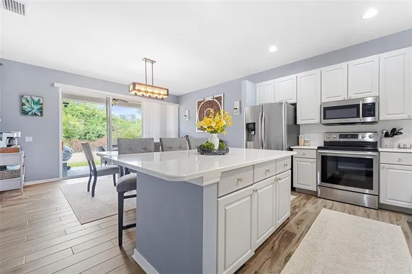 a kitchen with a stove a sink and a refrigerator