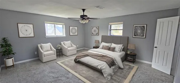 a bedroom with a large bed couch and a window
