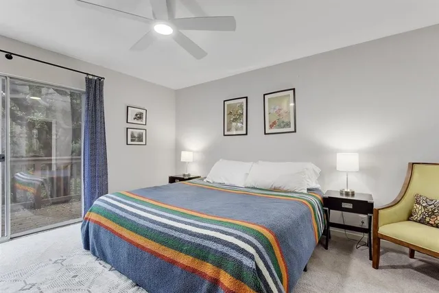 a bedroom with a bed and a painting on the wall