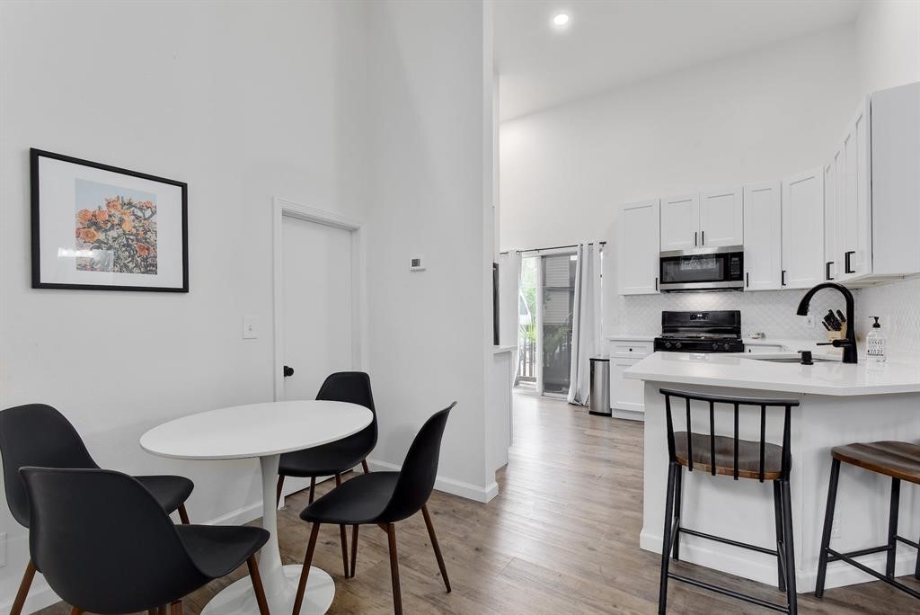 3201 South 5th Street, Unit B Austin, TX 78704 - Photo 16 of 25 a view of a dining room with furniture and wooden floor