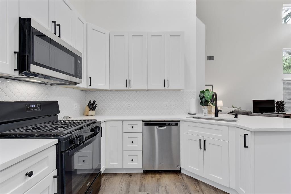 3201 South 5th Street, Unit B Austin, TX 78704 - Photo 18 of 25 a kitchen with white cabinets and appliances