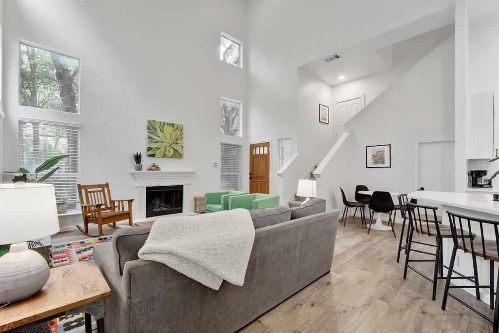 3201 South 5th Street, Unit B Austin, TX 78704 - Photo 9 of 25 a living room with furniture a fireplace and a table