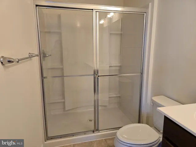 a bathroom with a shower a toilet and sink