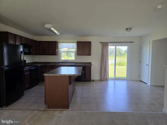 a kitchen with large cabinets and a refrigerator