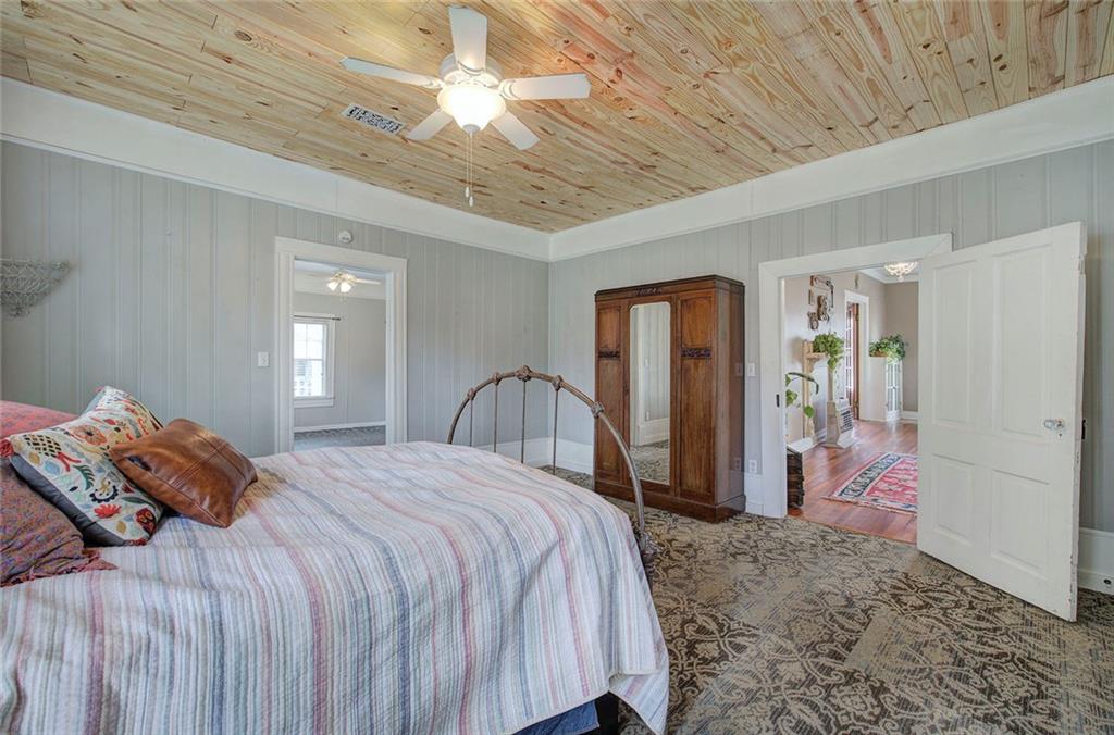 401 Edison Street Menlo, GA 30731 - Photo 22 of 34 a bedroom with a large bed and a chandelier