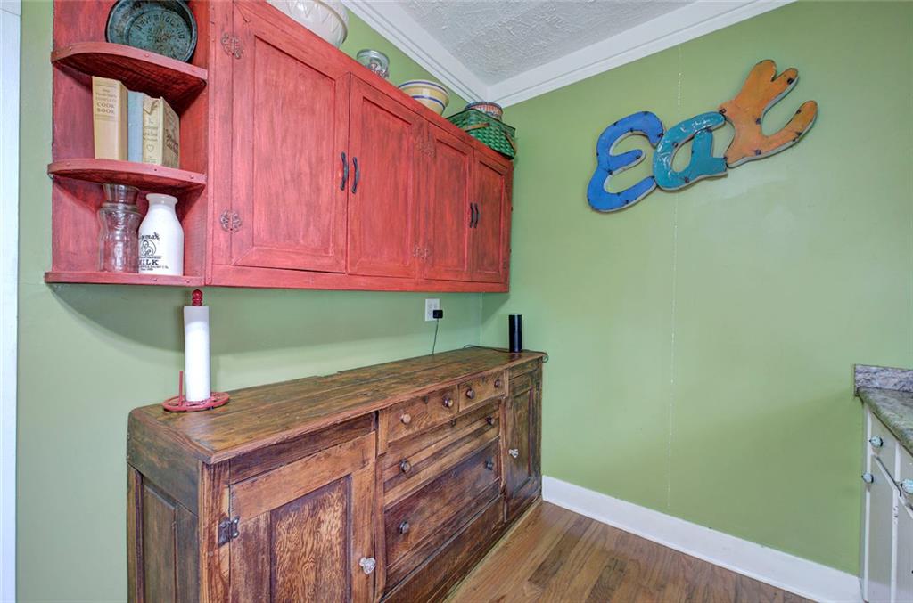 401 Edison Street Menlo, GA 30731 - Photo 31 of 34 a kitchen with a wooden floor and cabinets