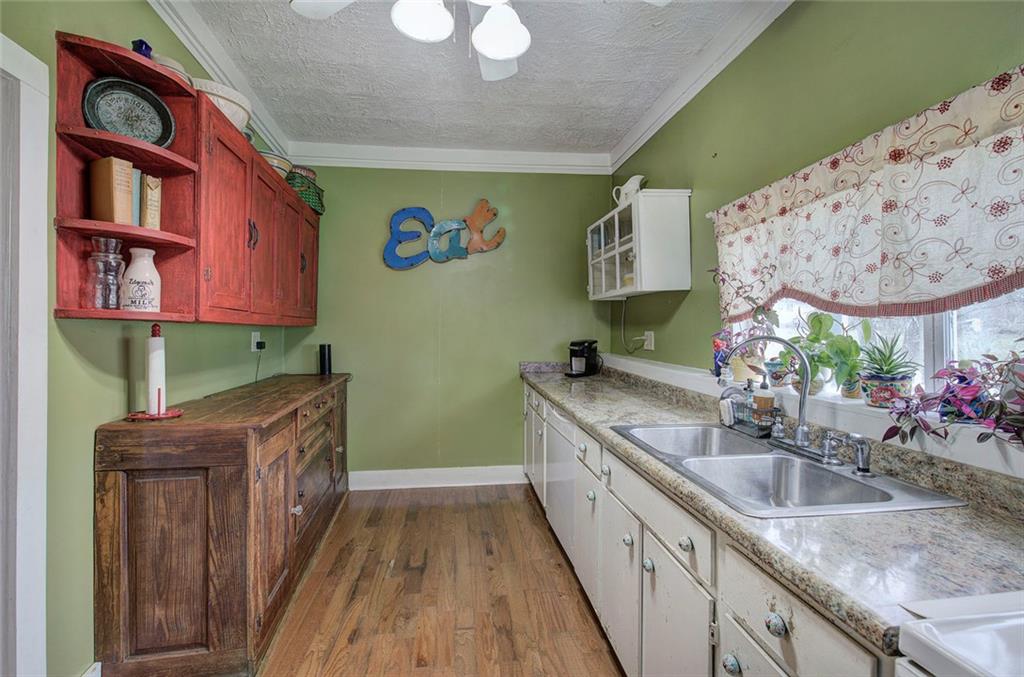 401 Edison Street Menlo, GA 30731 - Photo 33 of 34 a kitchen with stainless steel appliances granite countertop a sink a stove and a wooden cabinets