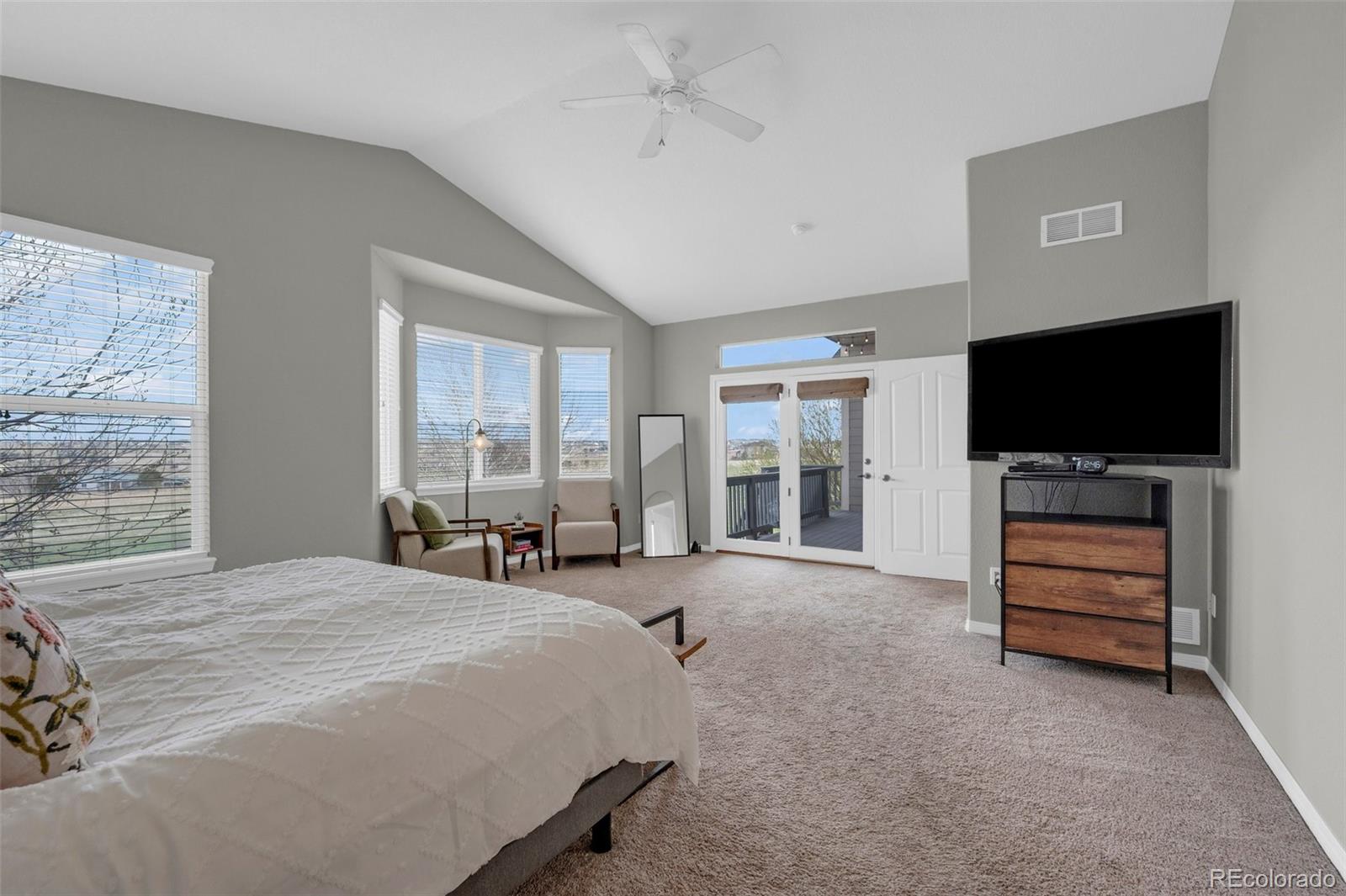 2382 Antelope Ridge Trail Parker, CO 80138 - Photo 14 of 34 a bedroom with a bed and a flat screen tv