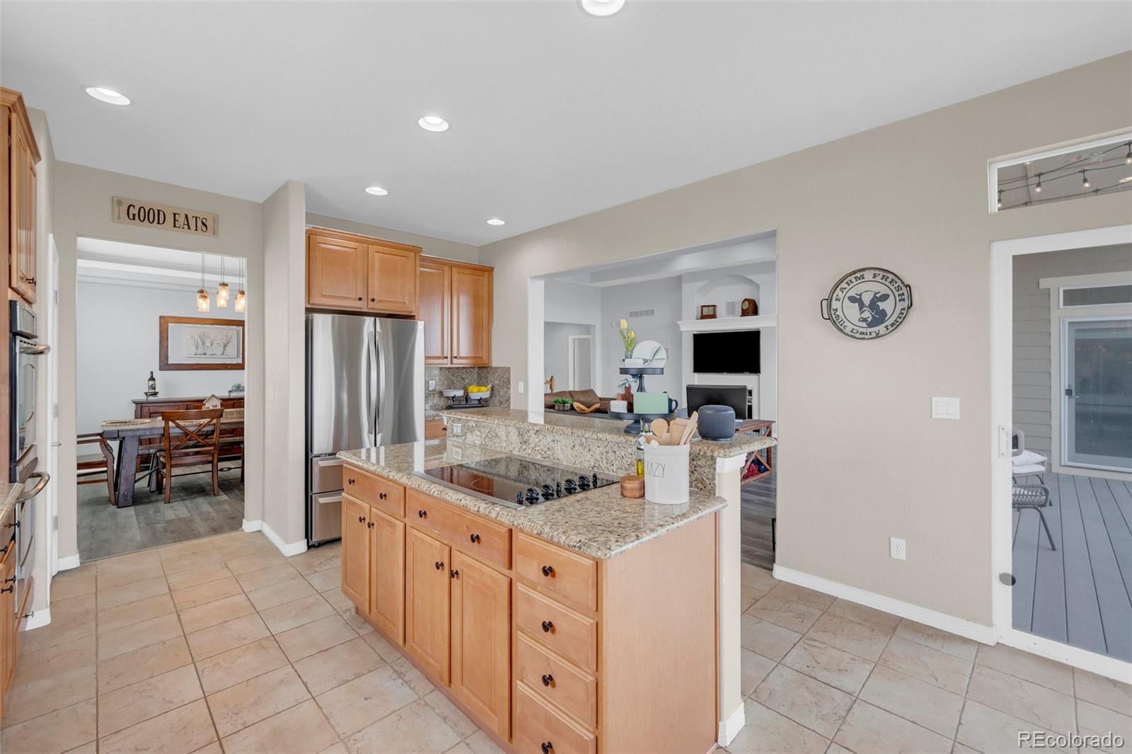 2382 Antelope Ridge Trail Parker, CO 80138 - Photo 16 of 49 a kitchen with stainless steel appliances granite countertop a refrigerator and a stove top oven