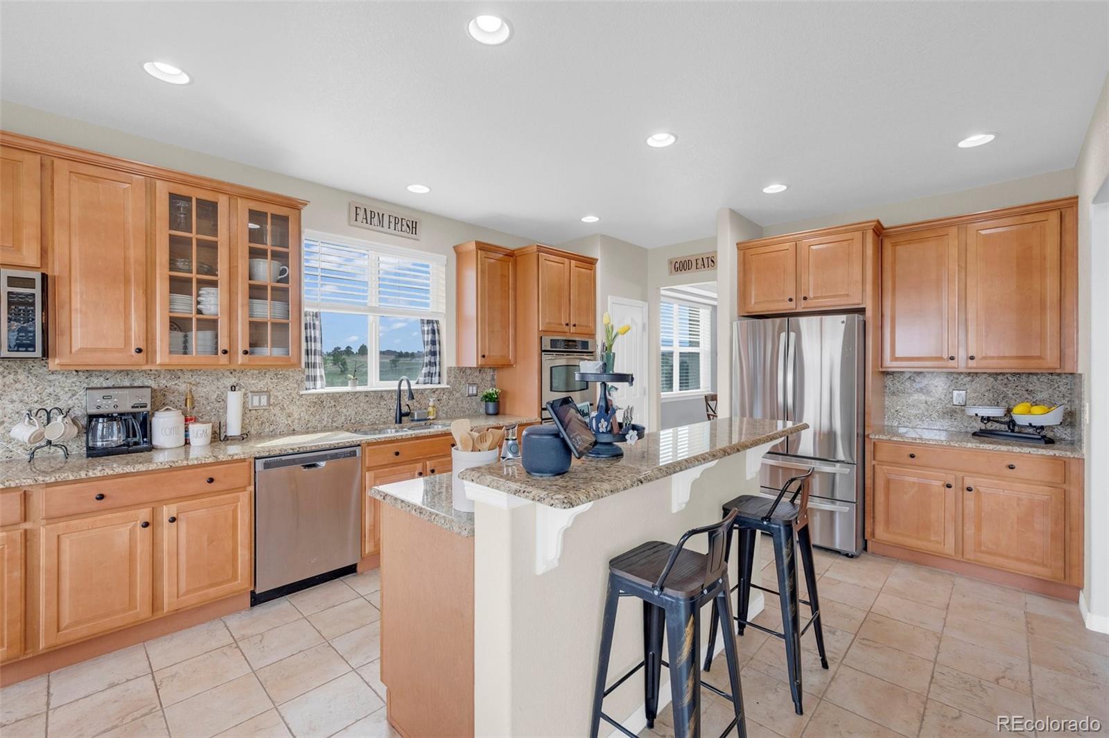 2382 Antelope Ridge Trail Parker, CO 80138 - Photo 17 of 49 a kitchen with stainless steel appliances kitchen island granite countertop a sink and cabinets
