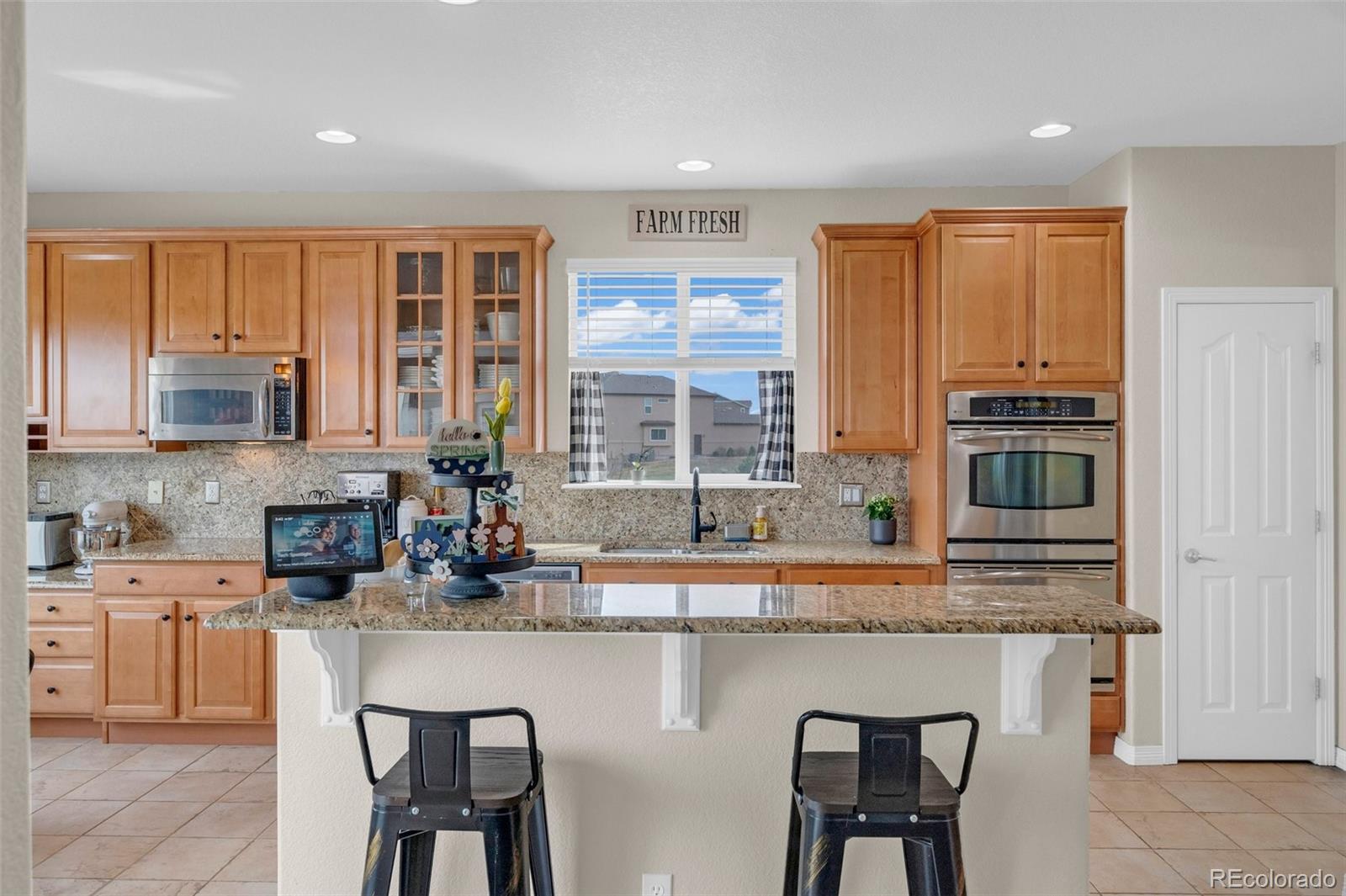 2382 Antelope Ridge Trail Parker, CO 80138 - Photo 20 of 49 a kitchen with stainless steel appliances granite countertop a stove a sink and a refrigerator