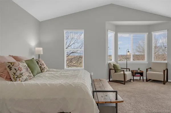 a bedroom with a bed and large window