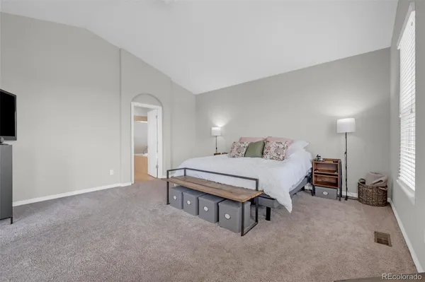 a bedroom with a bed and a lamp on table