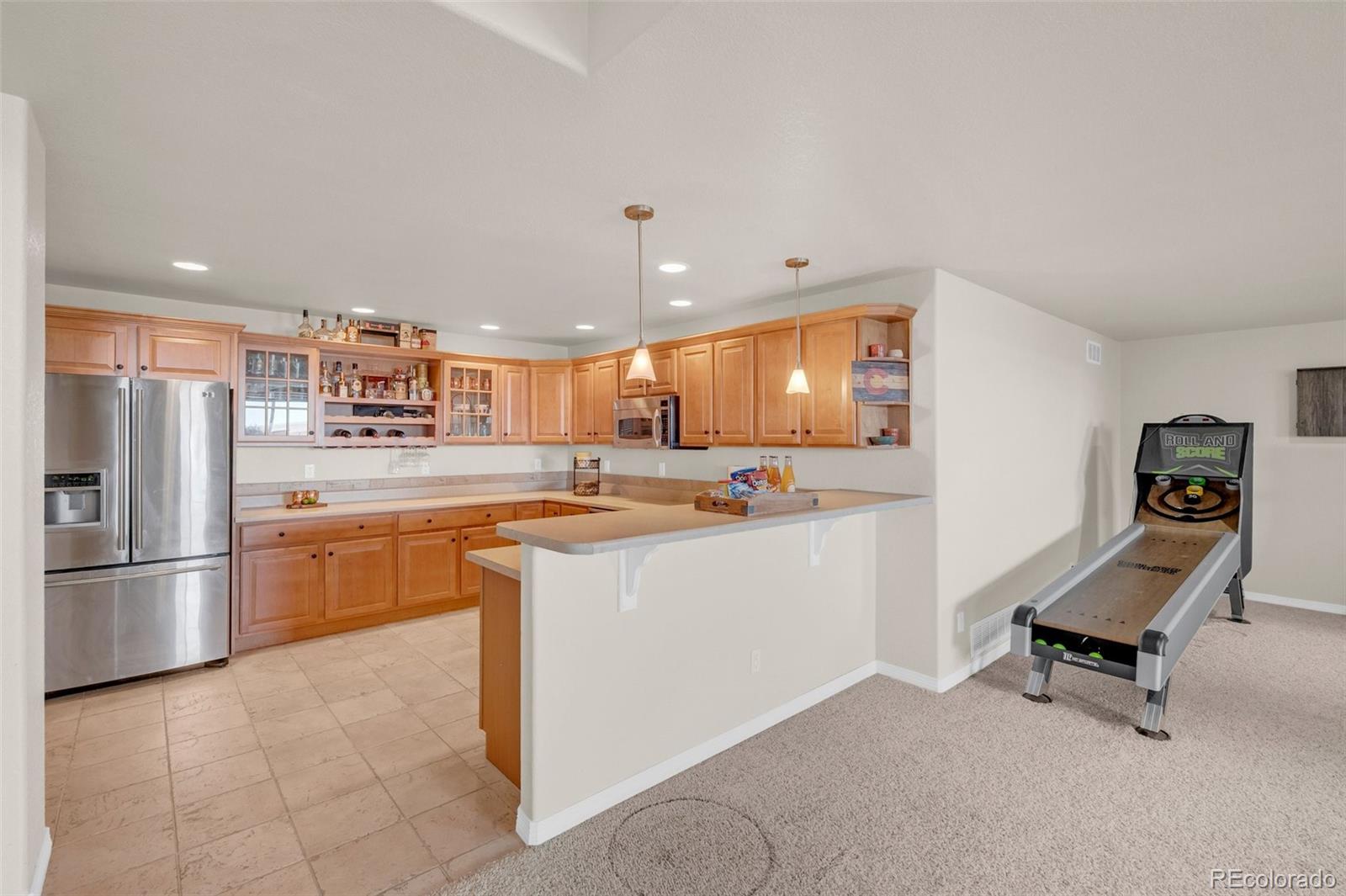 2382 Antelope Ridge Trail Parker, CO 80138 - Photo 22 of 34 a kitchen with stainless steel appliances kitchen island granite countertop a refrigerator and a stove top oven