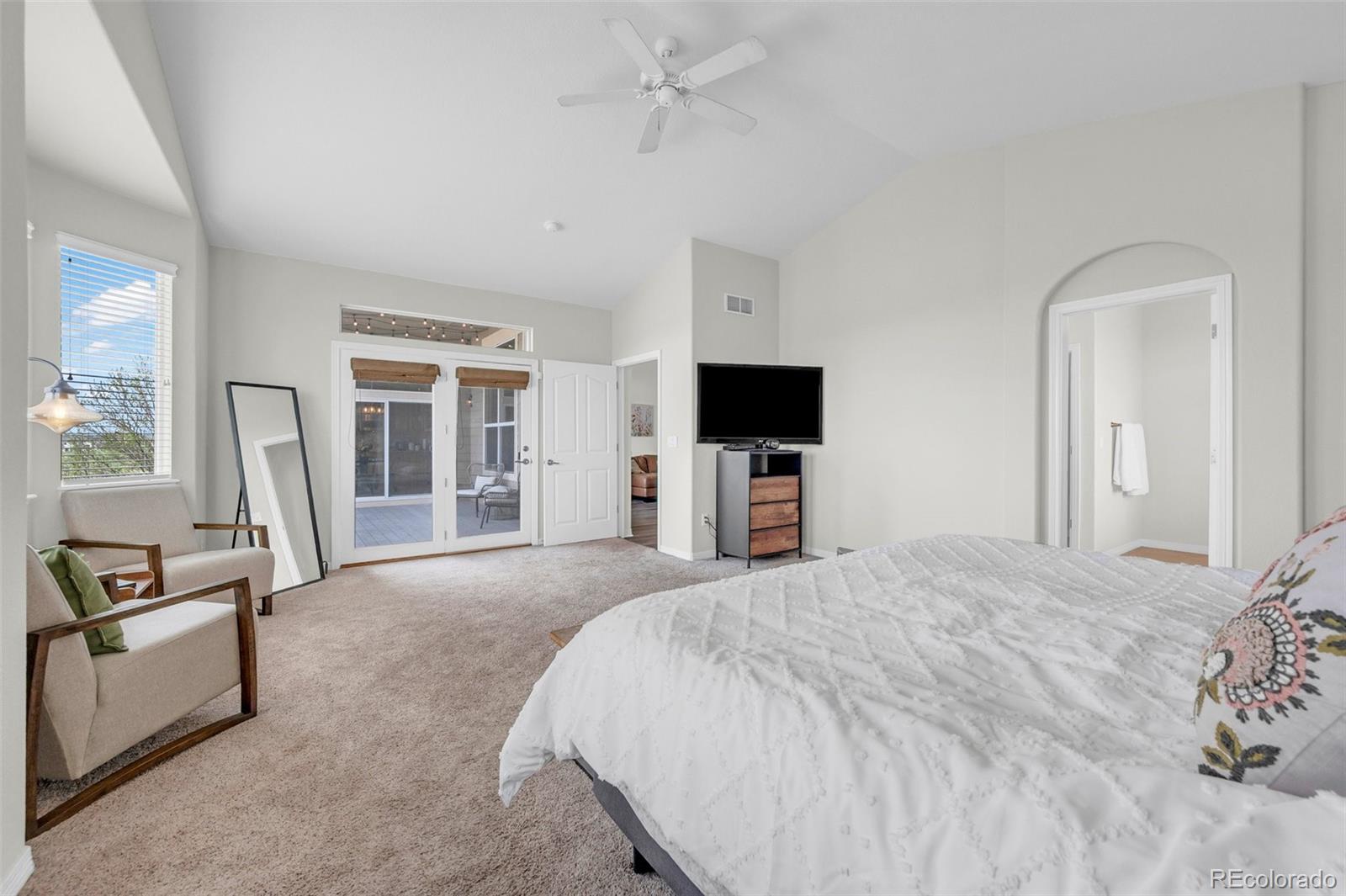 2382 Antelope Ridge Trail Parker, CO 80138 - Photo 23 of 49 a large bedroom with a bed and a flat screen tv