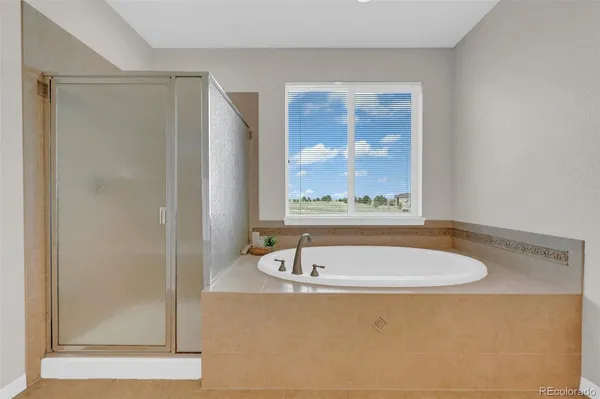 a bath tub sitting next to a bathroom sink