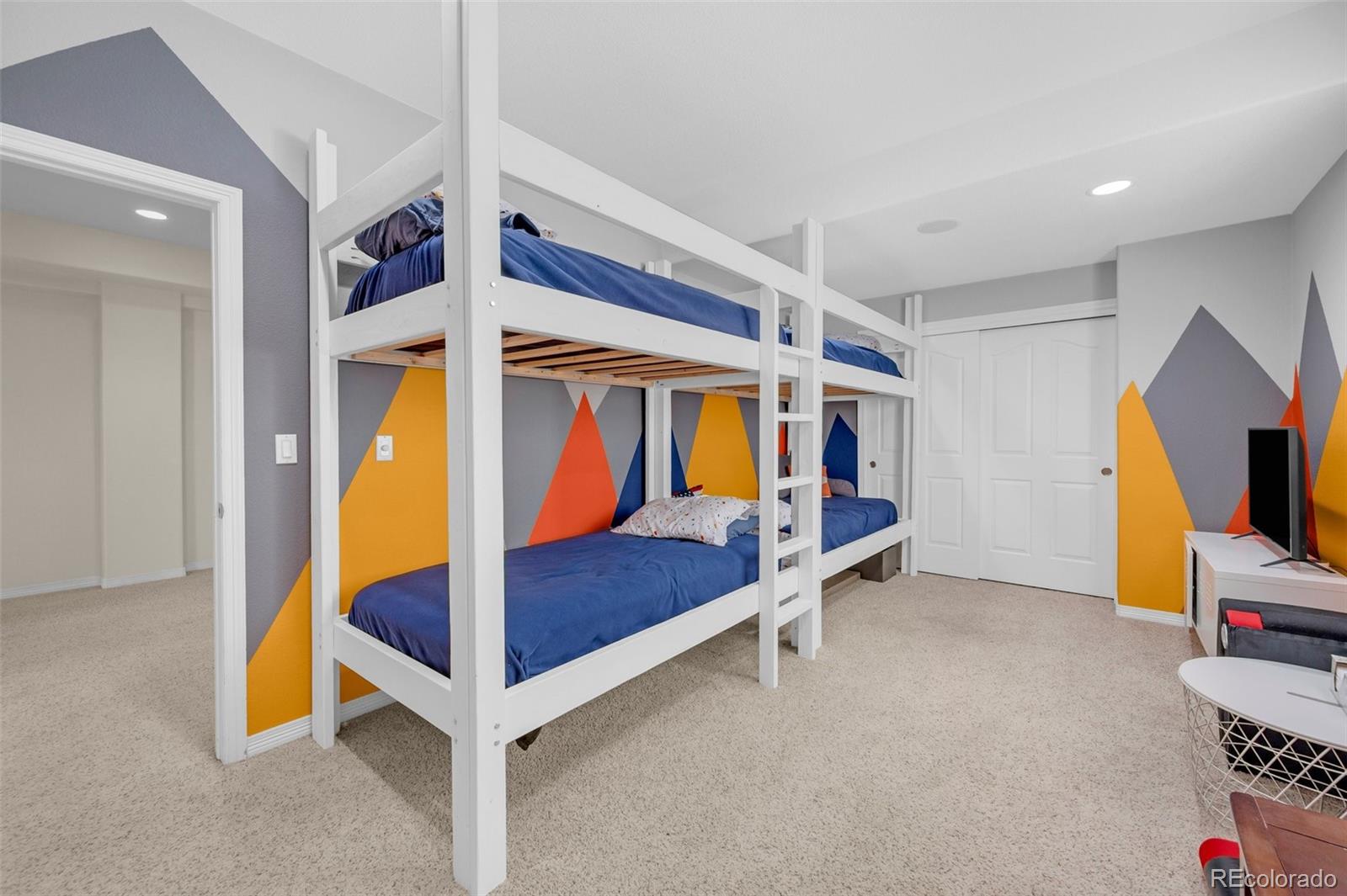 2382 Antelope Ridge Trail Parker, CO 80138 - Photo 27 of 34 a bedroom with furniture and a flat screen tv