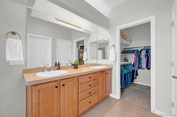 a spacious bathroom with a double vanity sink and a mirror