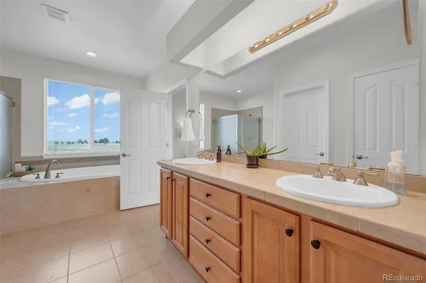 a bathroom with a granite countertop sink mirror and bathtub