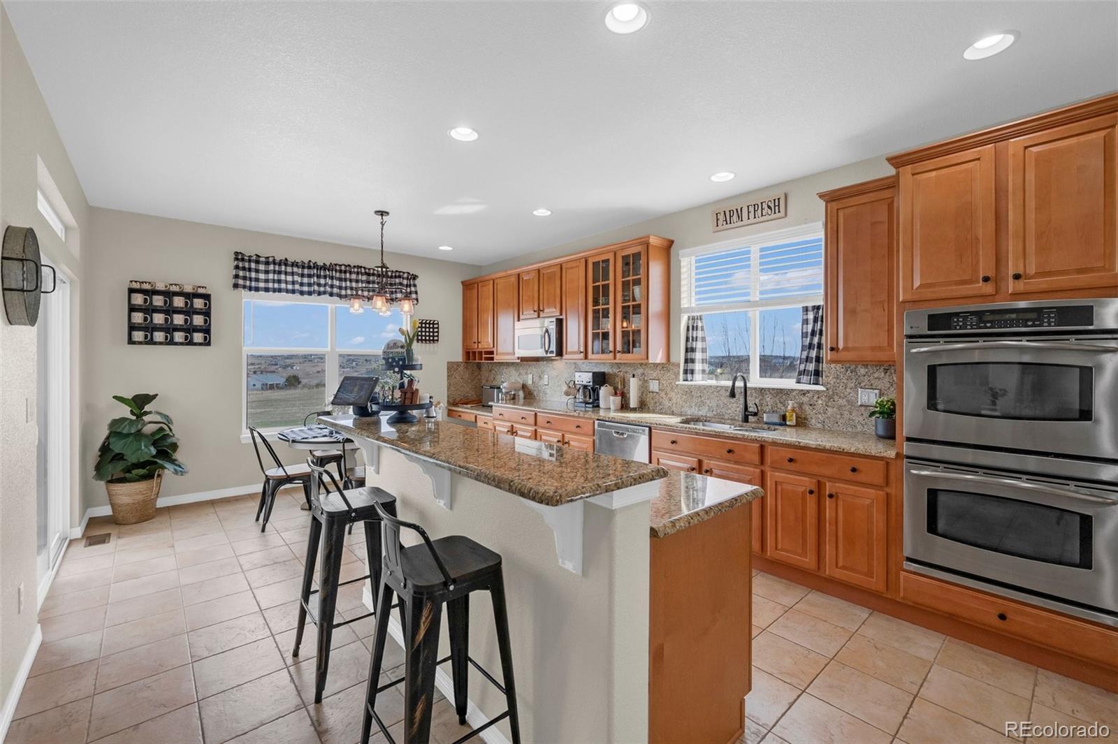 2382 Antelope Ridge Trail Parker, CO 80138 - Photo 3 of 34 a kitchen with stainless steel appliances granite countertop a stove top oven a sink dishwasher and a refrigerator