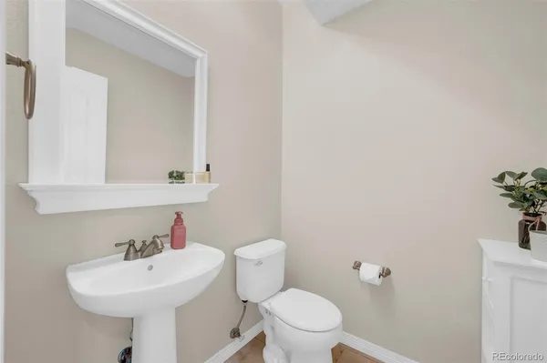 a bathroom with a sink a toilet and mirror