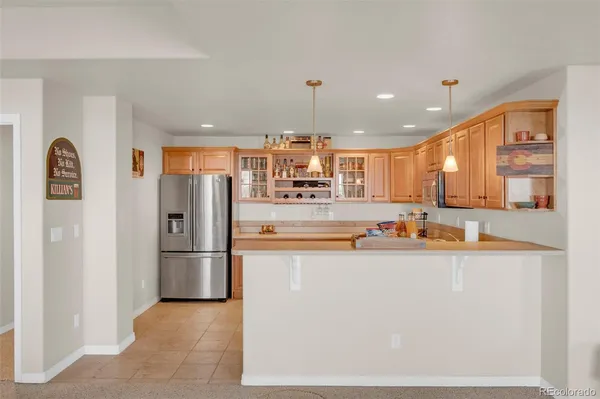 a kitchen with stainless steel appliances granite countertop a refrigerator and a stove top oven