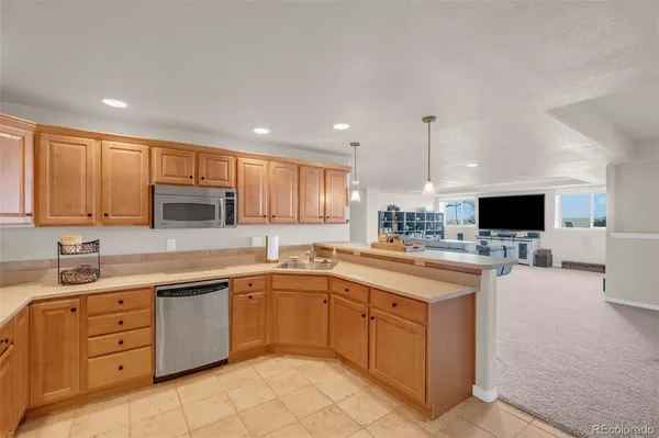 a kitchen with a sink stove and cabinets