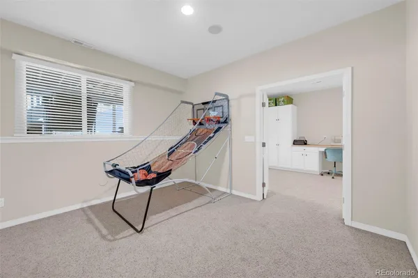a living room with furniture a air conditioner and a window
